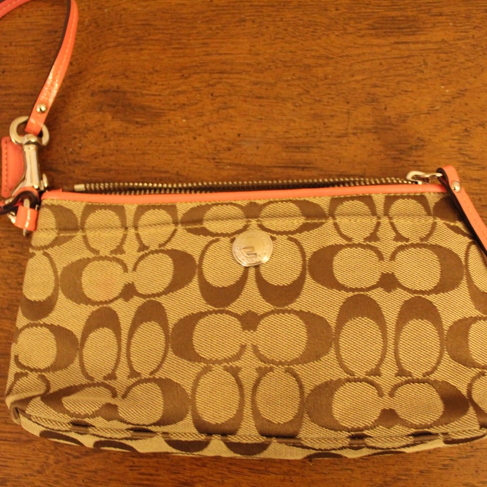Coach logo and peach patent leather trim wristlet