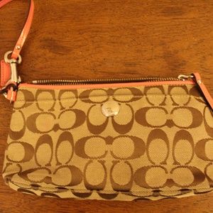 Coach logo and peach patent leather trim wristlet