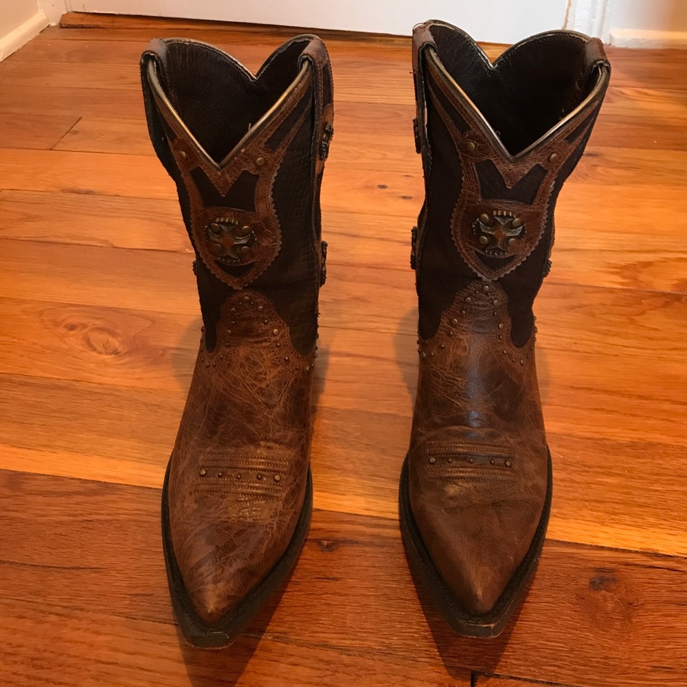 Ariat cowboy boots with metal embellishments.