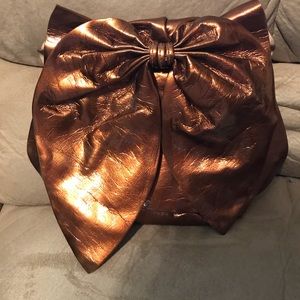 Copper clutch bag with bow