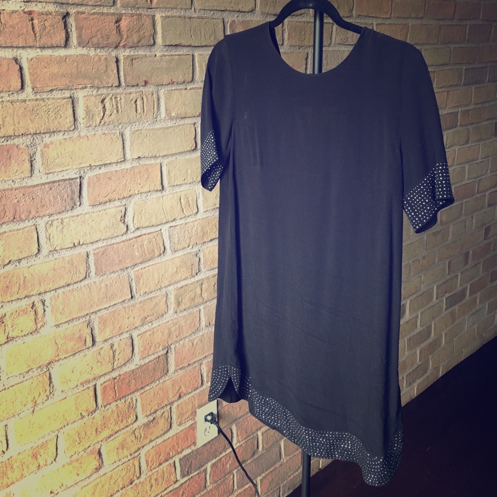 Black shift dress with studded hem