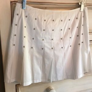 White pleated mini skirt.