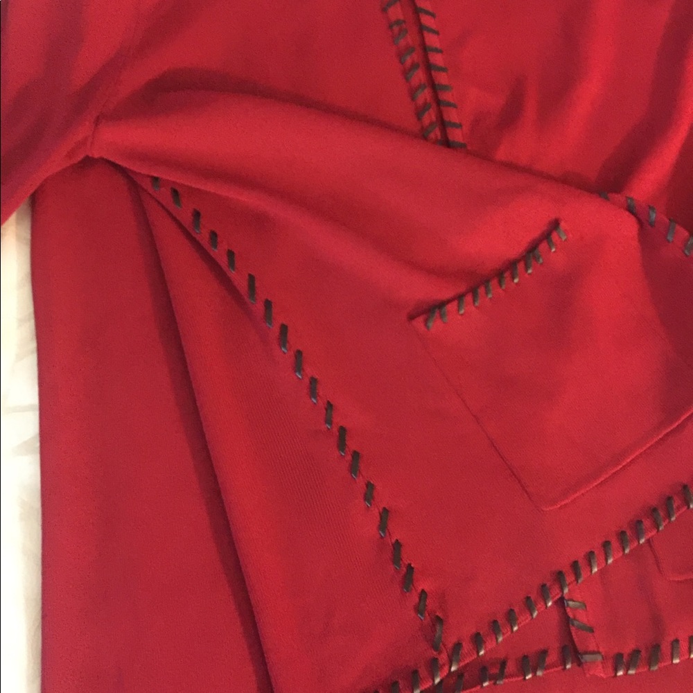 Red sweater set with black leather trim.