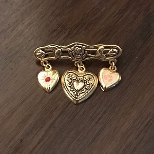 Three hearts pin with rose design, gold tone.