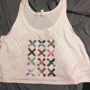 A white tank top with Tumbler X’s on it