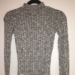 Girls tight fitting grey sweater turtleneck.