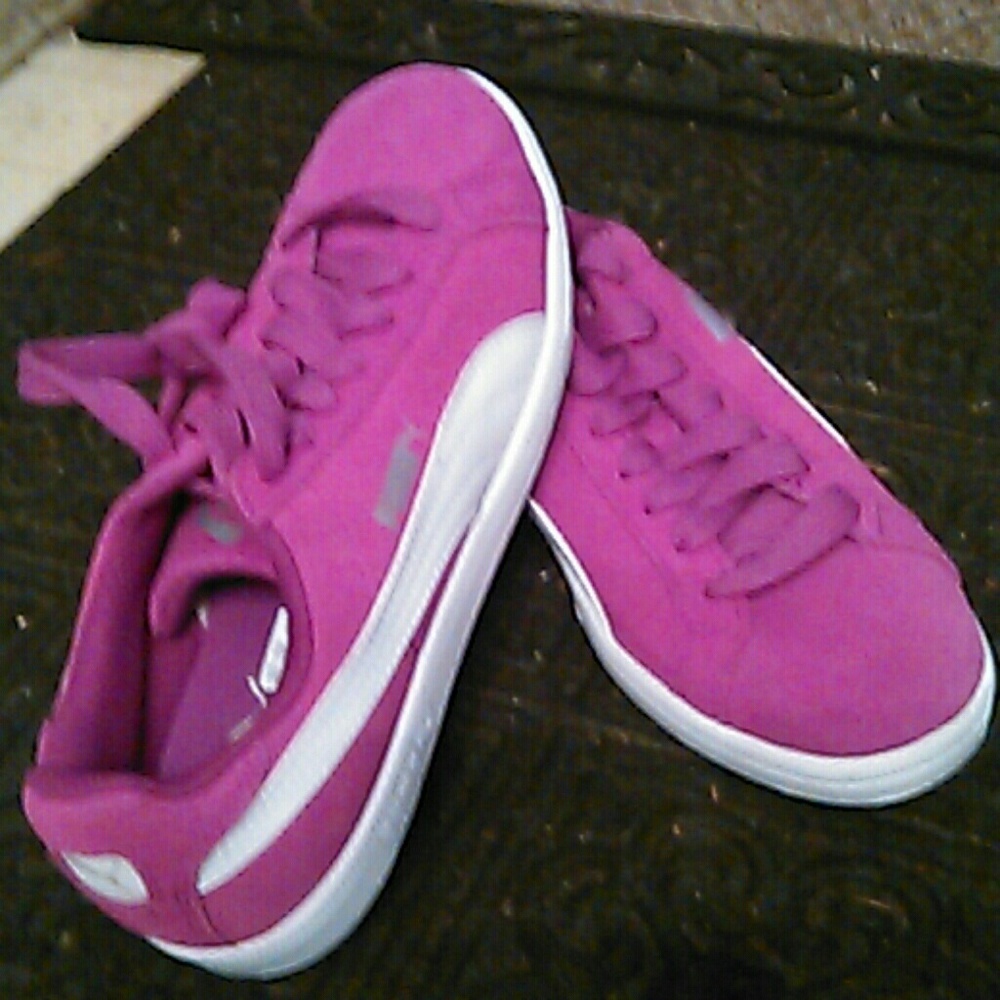 Pink suede sneakers with white strip along the sid