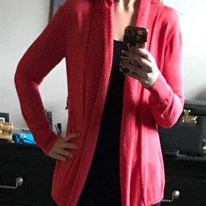 Orange light sweater with knit embellishments