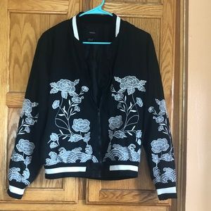 Black bomber jacket with embroidered gray flowers