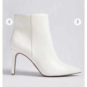 Pointed faux leather ankle boots in white.