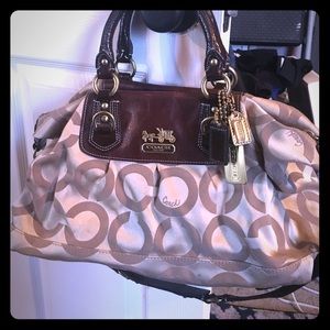 Medium to large size gold and brown Coach bag.