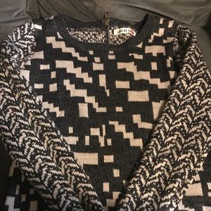 Multi design sweater w/ zipper accent in the back