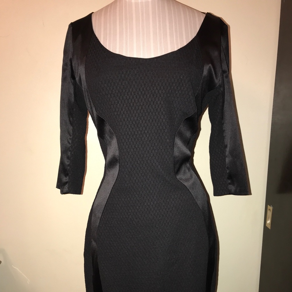 Fitted black dress with side detailing.