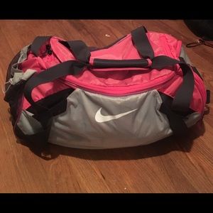 Pink and gray Nike duffel bag