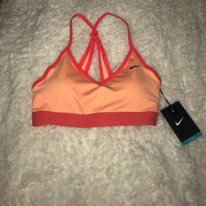 Small Nike sports bra in color orange and red