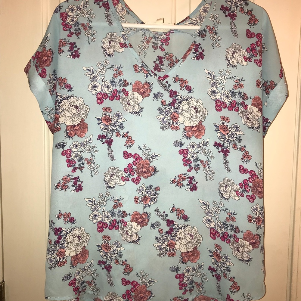 Light blue floral top.