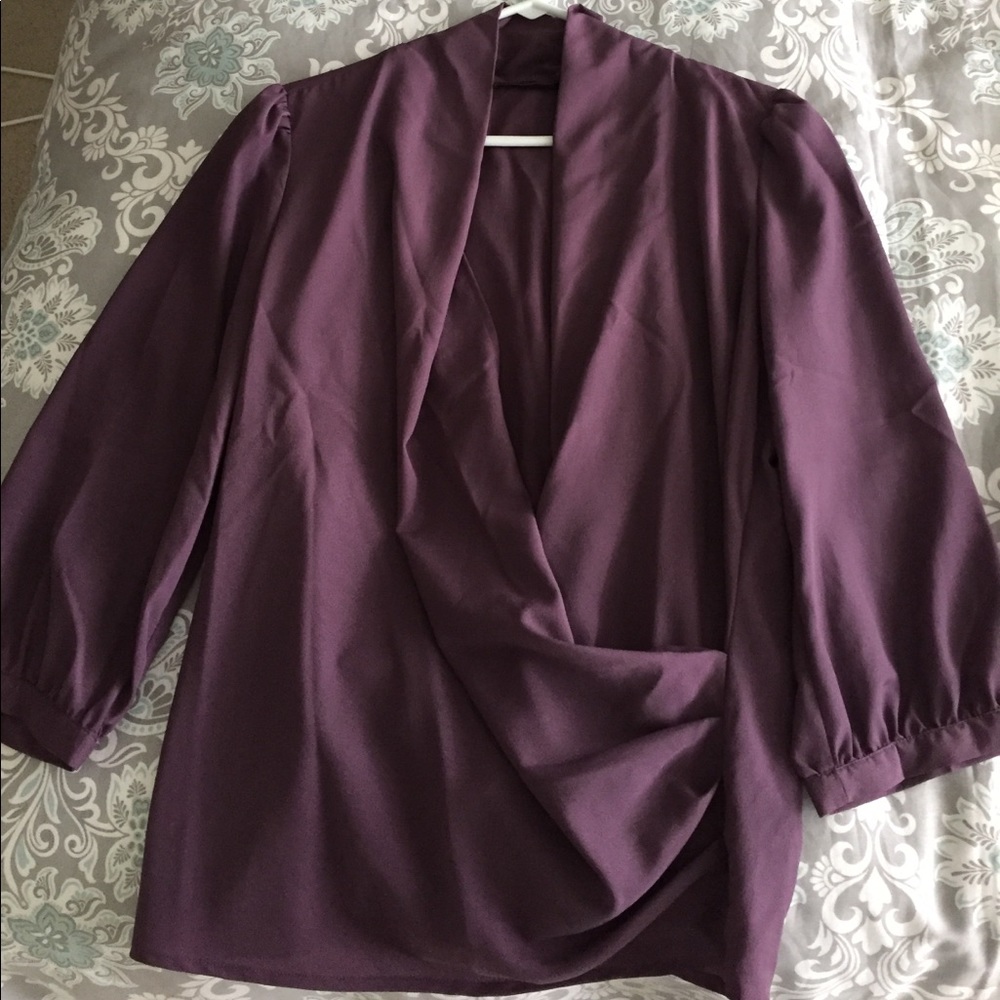 Plum blouse, draped neck.