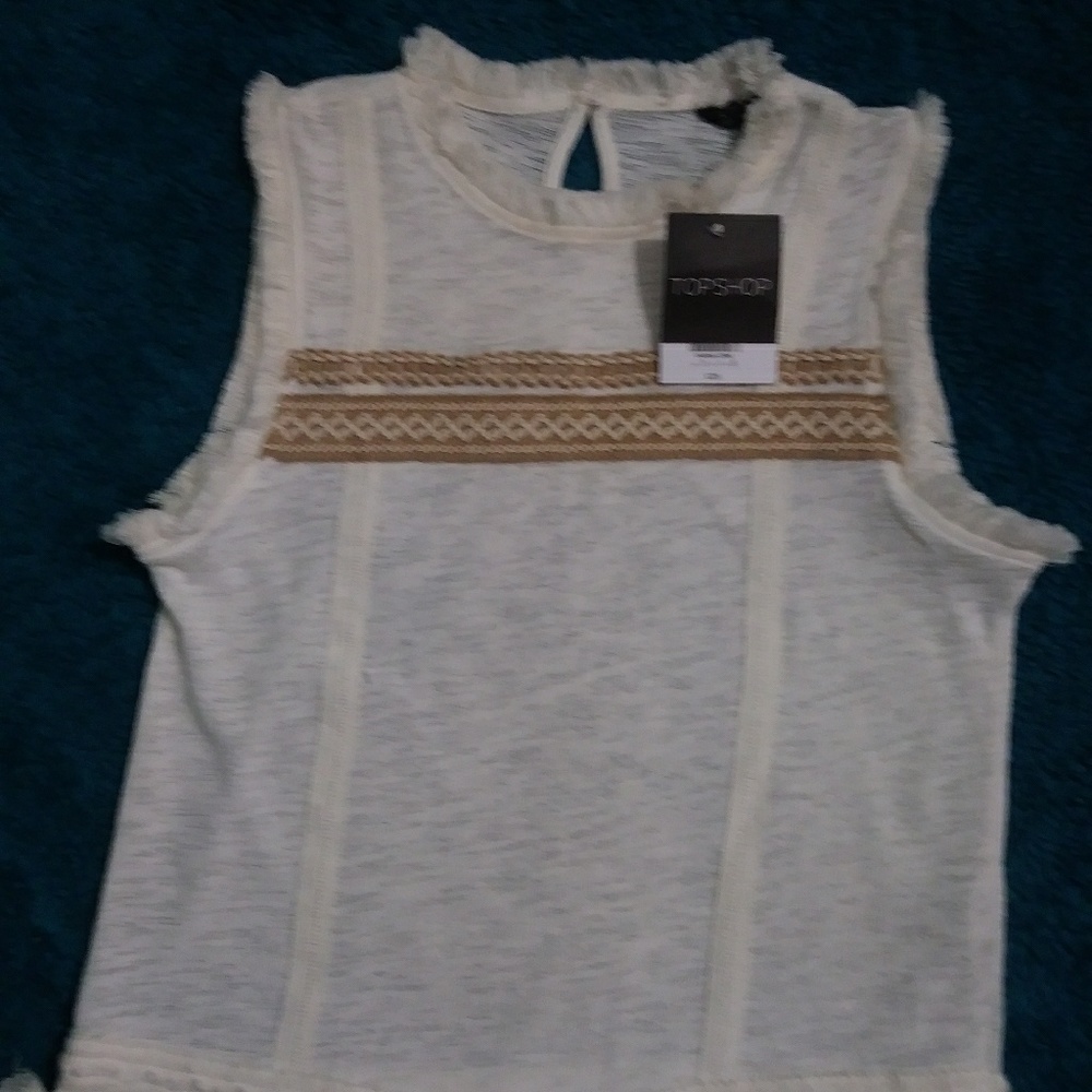 Sleeveless top with embroidery and fringe details
