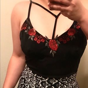 Black satin T strap stretchy top with rose detail