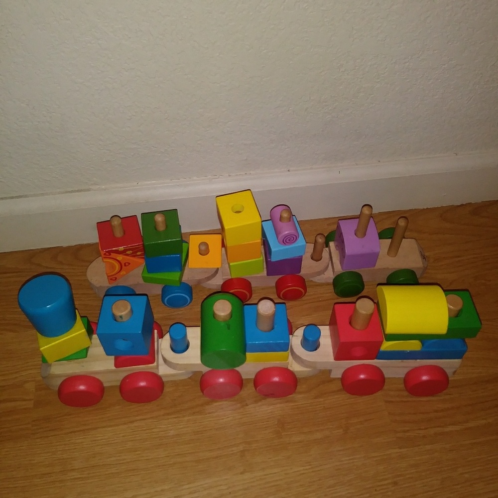 Two wooden train sets with stacking blocks