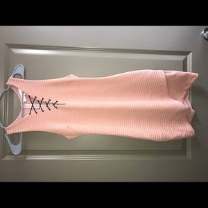 Peach body con dress with lace up detail