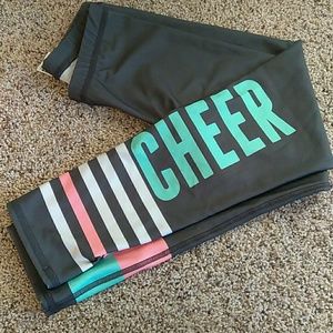 Gray leggings with white, pink, and blue stripes