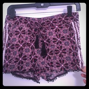 Woven printed short with Pom Pom trim.