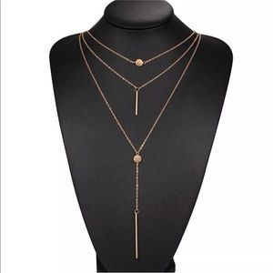 Layered gold necklace with single layer drop