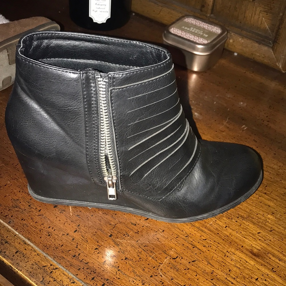 Super cute black booties. Zips on side.