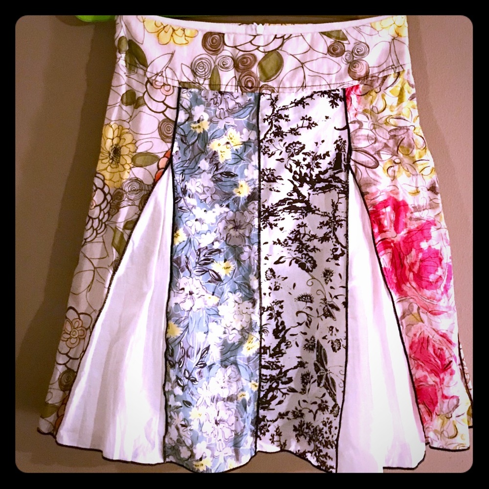 an MW above knees, mid length floral print skirt