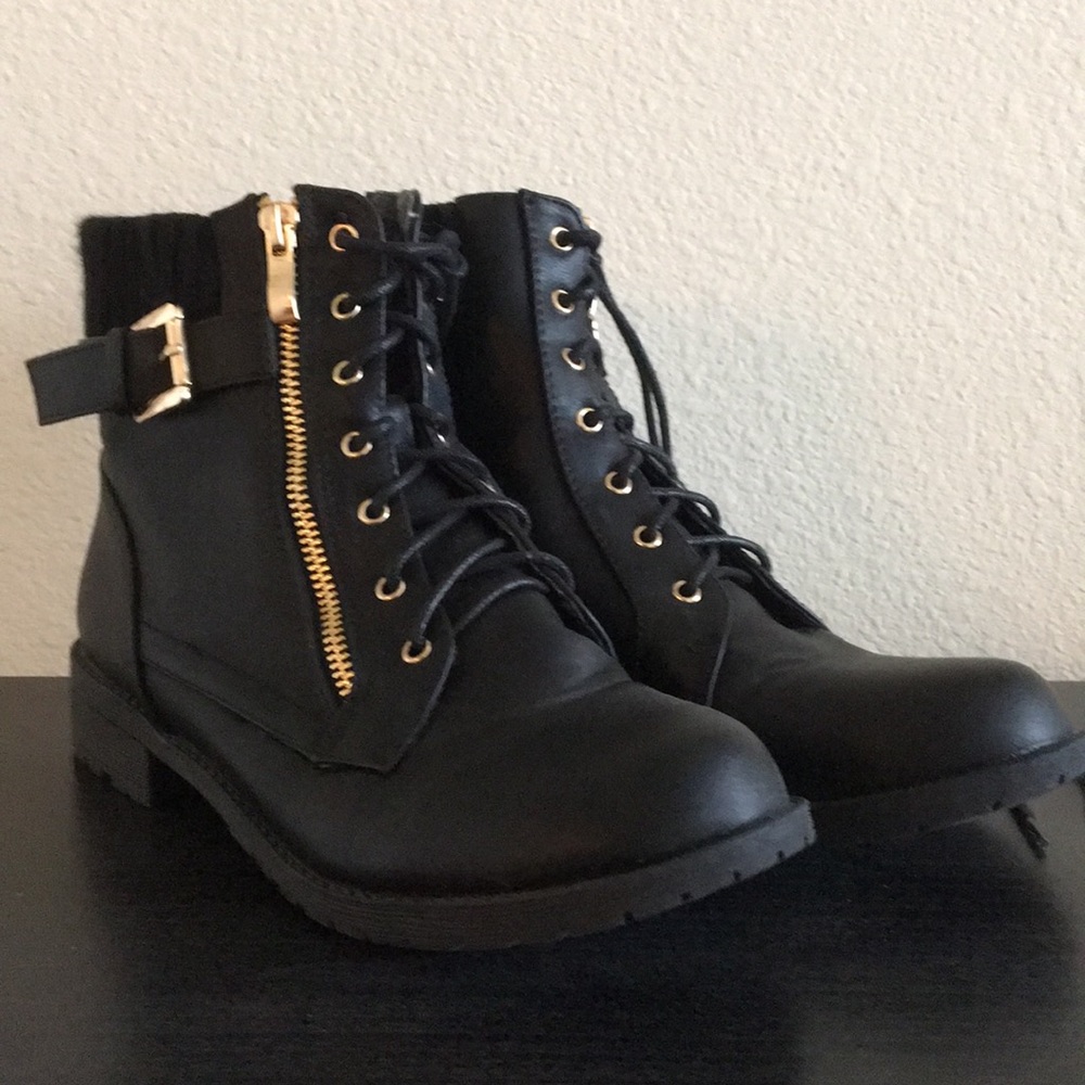 Black boots with gold zipper and buckle