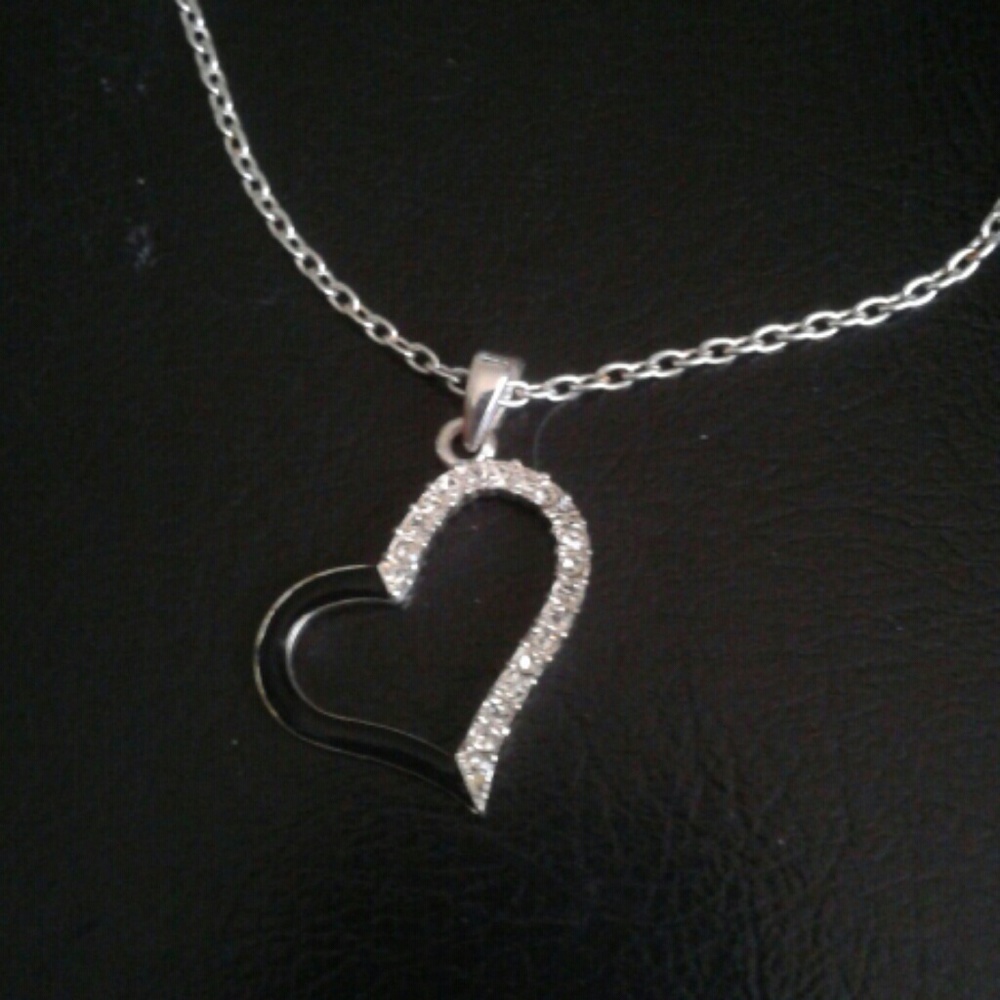 Heart with clear rhinestones half & black enamel half hangs on a slant
