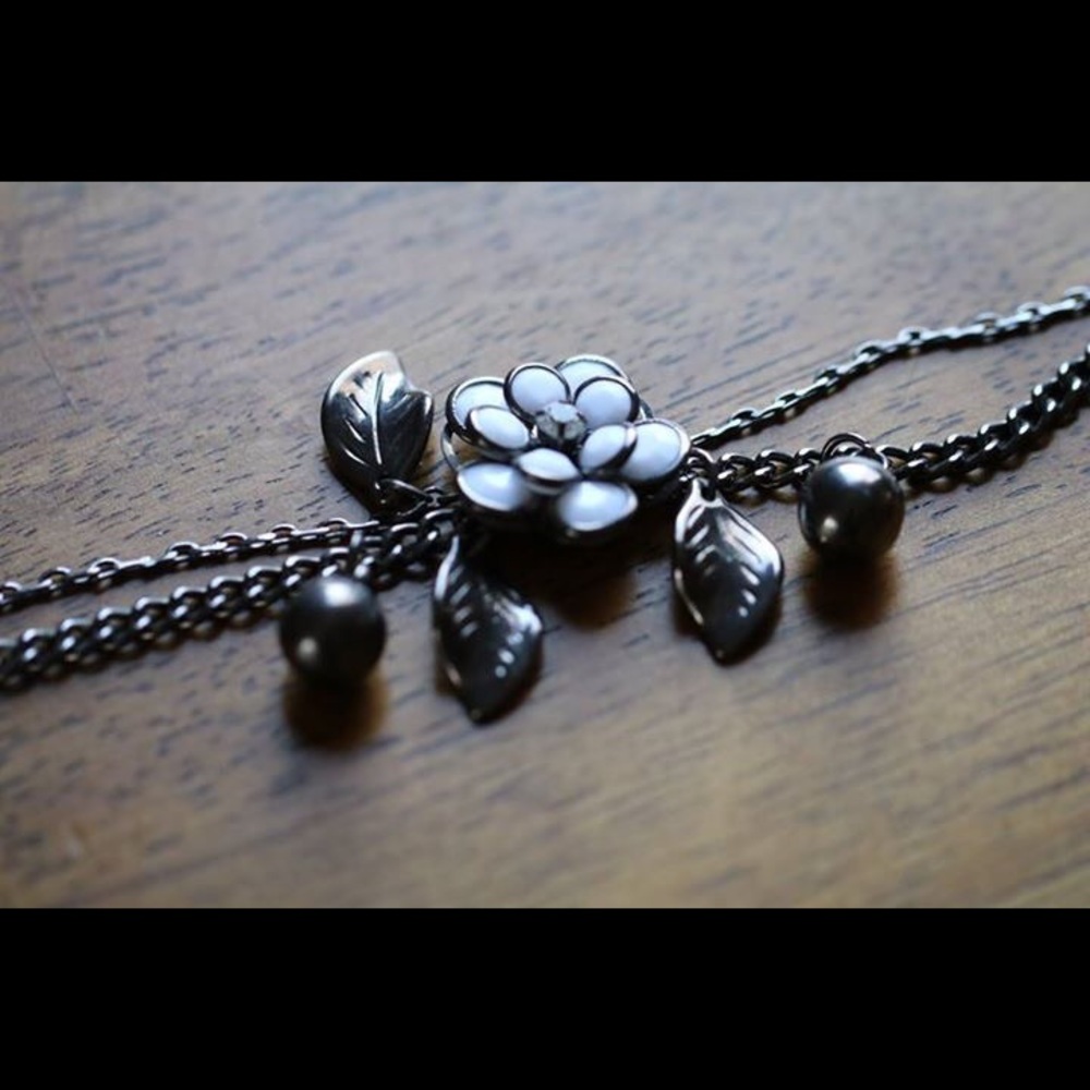 Dark grey bracelet with white flower