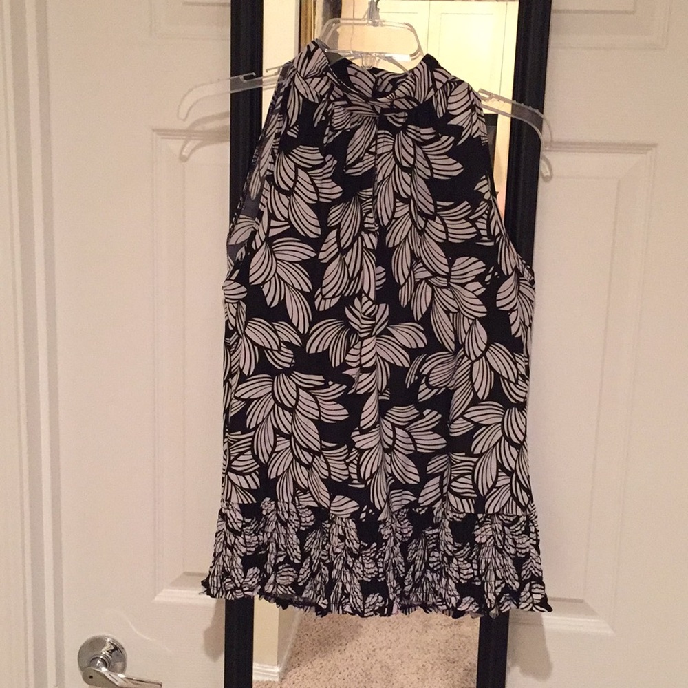 High-collar sleeveless blouse with keyhole details.