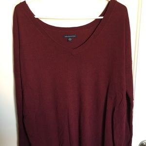 Long-sleeved, burgundy sweater.