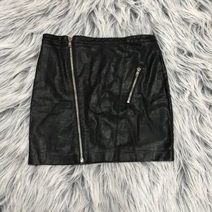 Black faux leather mini skirt with zipper detail .