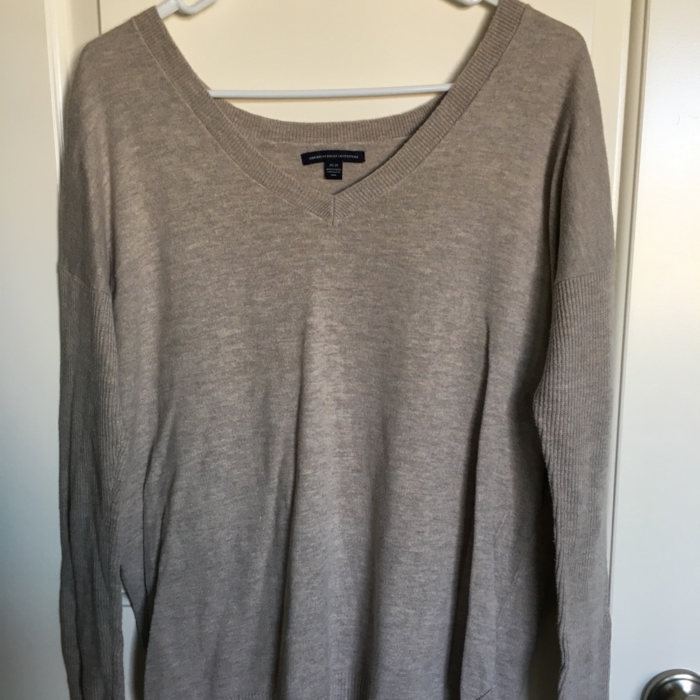 Long-sleeved, oatmeal sweater.
