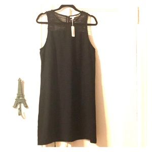 Black shift dress with mesh netted neckline...