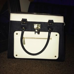 Stiff modern purse with cross body strap