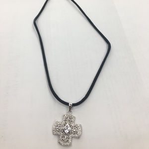Cross necklace on a black rope chain