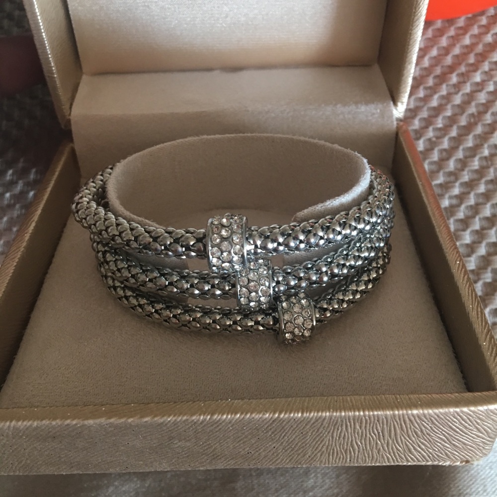 3 silver bracelets.