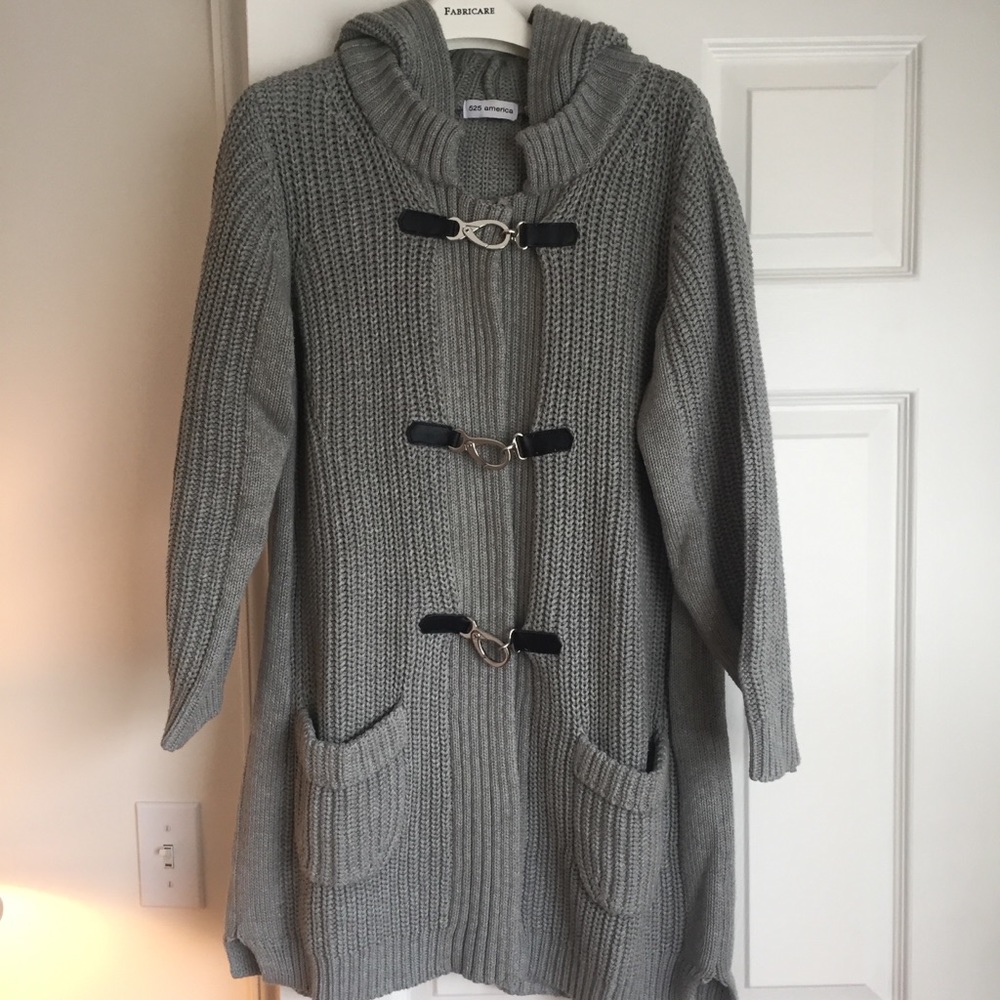 Cotton sweater with silver tone closure.