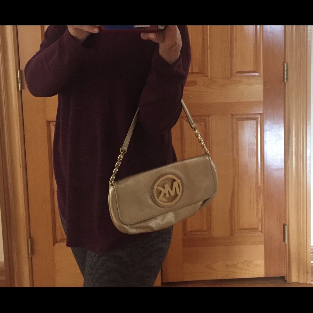 Brand new Micheal Kors gold clutch