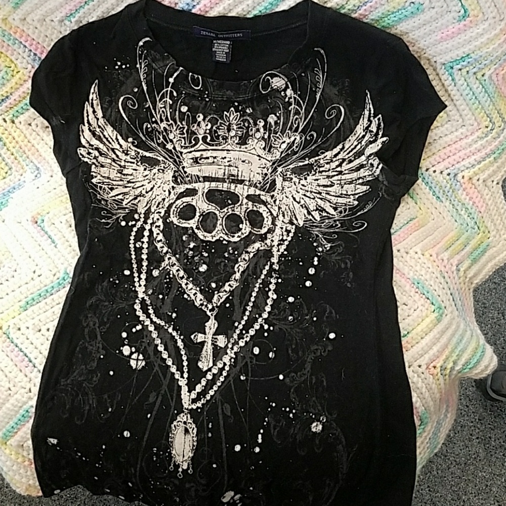 T-shirt. Runs kind of small. No jewels missing.