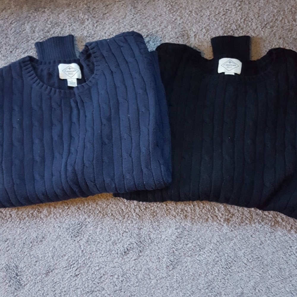Bundle of cable knit sweaters