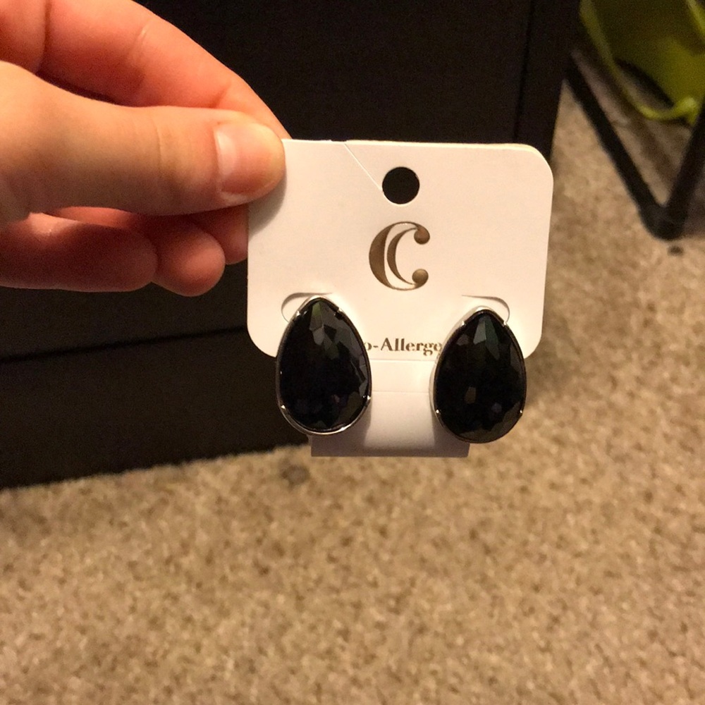 Women’s black studded earrings.