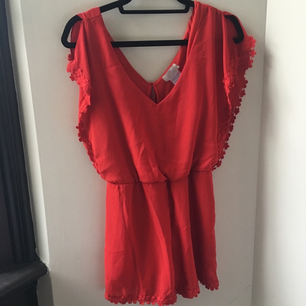 Red romper with floral trim