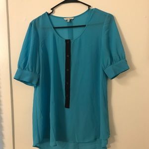 Beautiful bright blue blouse with black buttons