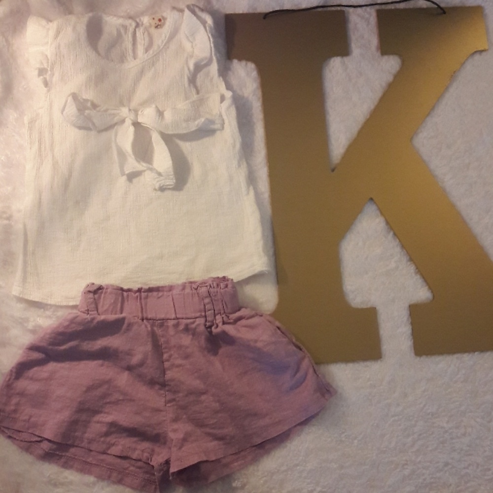 White top with bow on the front/ purple shorts