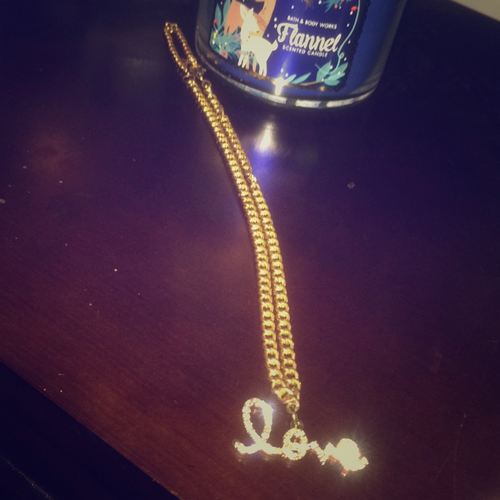 Gold necklace that says love on it